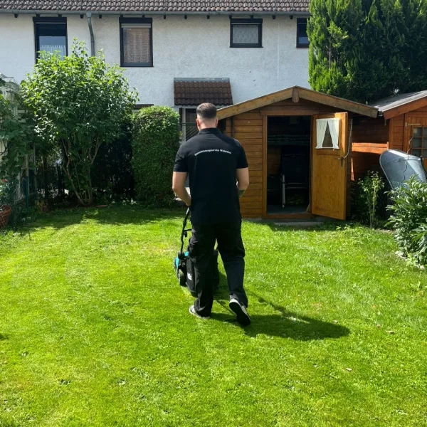 Rasenmähen im Garten eines Einfamilienhauses